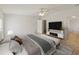 Comfortable main bedroom with large bed, bench and ensuite bath at 37639 Newport Dr, Zephyrhills, FL 33542