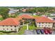 Great view of a community with well-maintained landscaping, parking and tennis courts at 404 Hammock Pine Blvd # 404, Clearwater, FL 33761