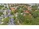 Scenic aerial view of community featuring lush landscaping, mature trees, and well-maintained red tile roof homes at 404 Hammock Pine Blvd # 404, Clearwater, FL 33761