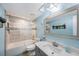 Bright bathroom with tub and shower combination, and vanity with modern fixtures at 404 Hammock Pine Blvd # 404, Clearwater, FL 33761