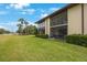 Beautiful view of property featuring well-manicured lawn and patio at 404 Hammock Pine Blvd # 404, Clearwater, FL 33761