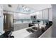 Bright kitchen with stainless steel appliances, white cabinetry, quartz countertops, and modern lighting at 404 Hammock Pine Blvd # 404, Clearwater, FL 33761