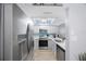 Bright kitchen features stainless steel appliances, white countertops, and light wood-look floors at 404 Hammock Pine Blvd # 404, Clearwater, FL 33761