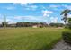 Spacious and well-maintained lawn area with mature trees and community features at 404 Hammock Pine Blvd # 404, Clearwater, FL 33761