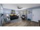 Comfortable living room with modern ceiling fan, wood flooring, stylish decor, and lots of natural light at 404 Hammock Pine Blvd # 404, Clearwater, FL 33761
