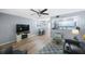 Cozy living room featuring an electric fireplace, wood flooring, and open access to the dining area at 404 Hammock Pine Blvd # 404, Clearwater, FL 33761