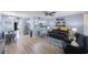 Open concept living room with wood floors, stylish furniture, and open access to the bright kitchen at 404 Hammock Pine Blvd # 404, Clearwater, FL 33761
