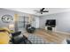 Bright living room with large window, modern ceiling fan, and comfortable seating, perfect for relaxing at 404 Hammock Pine Blvd # 404, Clearwater, FL 33761