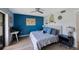 Bright bedroom featuring coastal decor, a workspace, and plenty of natural light at 404 Hammock Pine Blvd # 404, Clearwater, FL 33761