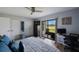 Bright bedroom with patio access, closet space and dedicated workspace at 404 Hammock Pine Blvd # 404, Clearwater, FL 33761