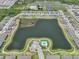 Aerial view of a community, featuring a lake, community pool, and rows of houses at 413 Royal Empress Dr, Ruskin, FL 33570