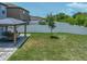 Spacious backyard with well-maintained lawn, patio with pergola, and a privacy fence at 413 Royal Empress Dr, Ruskin, FL 33570