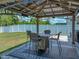 Backyard with outdoor dining area under gazebo, featuring a manicured lawn and privacy fence at 413 Royal Empress Dr, Ruskin, FL 33570