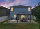 Back of house with a covered dining area, lush lawn, privacy fence, and an airy sky at 413 Royal Empress Dr, Ruskin, FL 33570