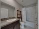 Neutral bathroom featuring a shower-tub combo with a white shower curtain, granite countertops, and tiled floors at 413 Royal Empress Dr, Ruskin, FL 33570