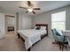 Carpeted bedroom with a window, closet, bed, ceiling fan, and a desk with a chair at 413 Royal Empress Dr, Ruskin, FL 33570