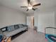 Bedroom with neutral walls, carpet, and ceiling fan, featuring a daybed, closet, and access to other rooms at 413 Royal Empress Dr, Ruskin, FL 33570