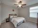 Bedroom with carpet and neutral walls, with a bed, side table, lamp, and large window at 413 Royal Empress Dr, Ruskin, FL 33570