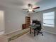 Bedroom with neutral walls, carpet, and ceiling fan, featuring a desk, computer setup, and office chair at 413 Royal Empress Dr, Ruskin, FL 33570