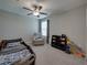 bedroom with carpet, a ceiling fan, a playful car-shaped bed and a storage bookcase at 413 Royal Empress Dr, Ruskin, FL 33570