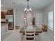 Dining room featuring a chandelier, white walls, tile flooring, and a wood table with seating for six at 413 Royal Empress Dr, Ruskin, FL 33570