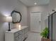 Bright foyer with a decorative mirror, white dresser, and tiled floor at 413 Royal Empress Dr, Ruskin, FL 33570