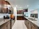 Modern kitchen features granite countertops, stainless steel appliances, and dark wood cabinetry at 413 Royal Empress Dr, Ruskin, FL 33570