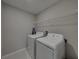 Practical laundry room is equipped with a washer, dryer, and wire shelving for storage at 413 Royal Empress Dr, Ruskin, FL 33570