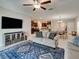 Bright open-concept living room with tile flooring, ceiling fan, open access to kitchen and dining area at 413 Royal Empress Dr, Ruskin, FL 33570