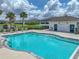 Resort-style community pool with a bathhouse and lounge seating at 413 Royal Empress Dr, Ruskin, FL 33570