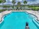 Inviting community pool with clear blue water and lounge chairs nearby at 413 Royal Empress Dr, Ruskin, FL 33570