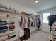 Large walk-in closet with wire shelving, hanging racks and carpeted flooring at 413 Royal Empress Dr, Ruskin, FL 33570