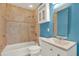 This bathroom features blue and beige tiling with a combined shower and tub at 4330 7Th N Ave, St Petersburg, FL 33713