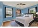 This is a bedroom with blue walls, hardwood floors, and lots of natural light at 4330 7Th N Ave, St Petersburg, FL 33713