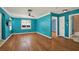 Large, brightly painted living room featuring ceiling fan, wood floors, and an entrance into the bathroom at 4330 7Th N Ave, St Petersburg, FL 33713