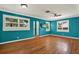 Bright living room showcasing wood floors, white trim, ceiling fan, and large windows with shutter-style blinds at 4330 7Th N Ave, St Petersburg, FL 33713