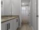 Modern bathroom featuring a double sink vanity with stone countertop and a shower with white curtain at 444 49Th N St, St Petersburg, FL 33710