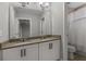 Modern bathroom featuring a double sink vanity with stone countertop, large mirror, and shower with white curtain at 444 49Th N St, St Petersburg, FL 33710
