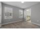 Comfortable bedroom showcasing two windows, neutral walls, and an ensuite bathroom at 444 49Th N St, St Petersburg, FL 33710