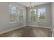 Bright dining area featuring hardwood floors and three large windows with natural light at 444 49Th N St, St Petersburg, FL 33710