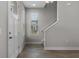Bright entryway with hardwood floors, staircase, and a white front door at 444 49Th N St, St Petersburg, FL 33710