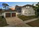 View of the home's exterior, showcasing the detached two car garage and extended driveway at 444 49Th N St, St Petersburg, FL 33710