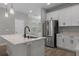 Bright kitchen featuring stainless steel refrigerator, quartz countertops, and modern faucet at 444 49Th N St, St Petersburg, FL 33710