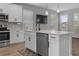 Modern kitchen with stainless steel appliances, island with sink, and hardwood floors at 444 49Th N St, St Petersburg, FL 33710