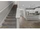 Bright living area featuring an open floor plan, sleek flooring, and modern kitchen with stainless steel appliances at 444 49Th N St, St Petersburg, FL 33710