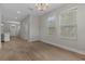 Bright living room with hardwood floors, large windows, and a modern chandelier at 444 49Th N St, St Petersburg, FL 33710