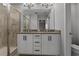 Elegant bathroom featuring a double vanity, sleek cabinetry, and a glass-enclosed shower for a spa-like experience at 444 49Th N St, St Petersburg, FL 33710
