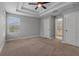 Large main bedroom showcasing tray ceilings, a window, and access to the ensuite bathroom for added privacy at 444 49Th N St, St Petersburg, FL 33710