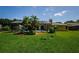 A large backyard features a screened-in pool and patio with mature landscaping at 4452 Bardsdale Dr, Palm Harbor, FL 34685