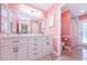 Bright bathroom with a double sink vanity and a flamingo themed shower at 4452 Bardsdale Dr, Palm Harbor, FL 34685
